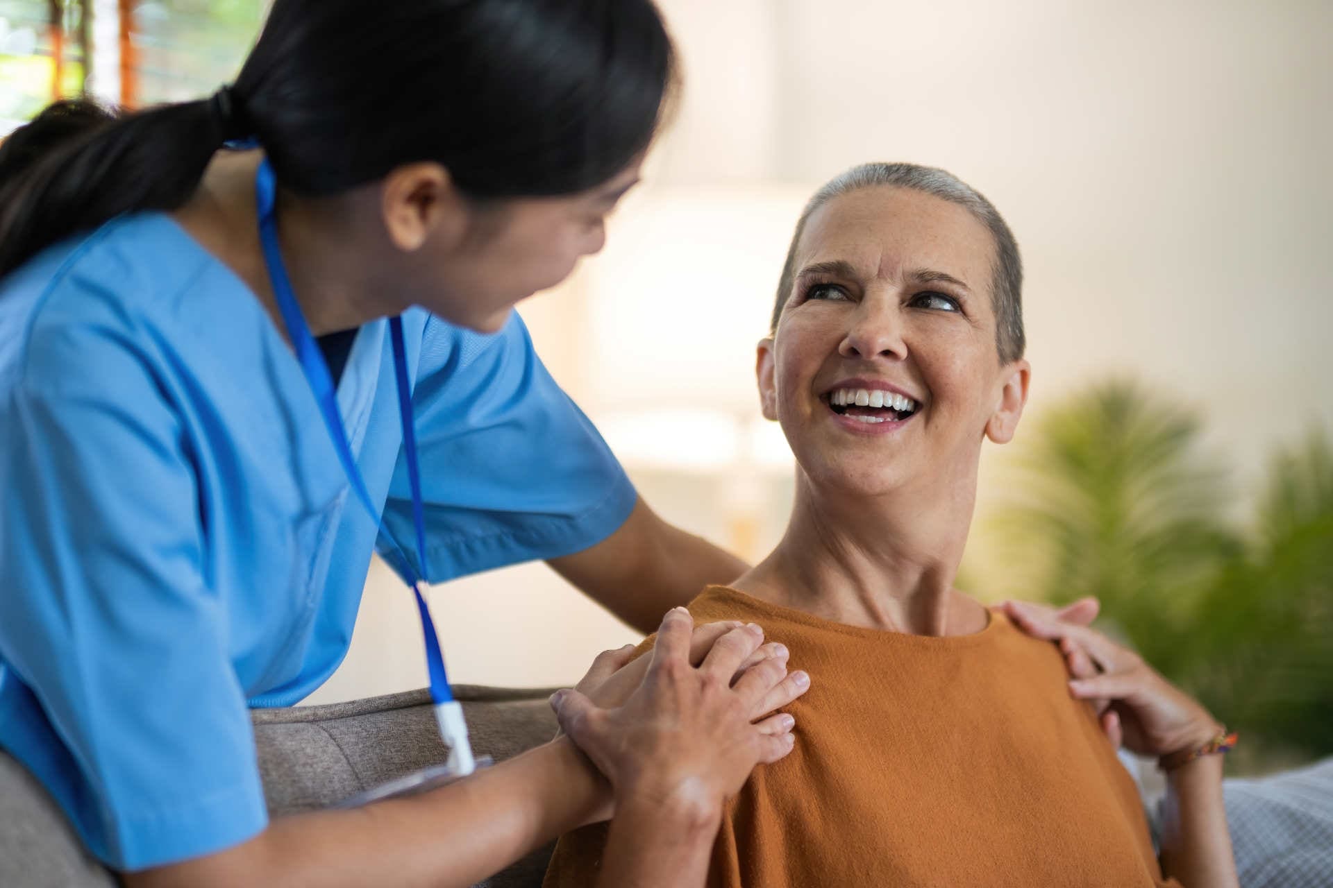 Physical therapist caregiver Asian and Caucasian senior women trust moving hand in rehabilitation. Physiotherapy healthcare, Medical caregiver consulting disabled elderly patient at home